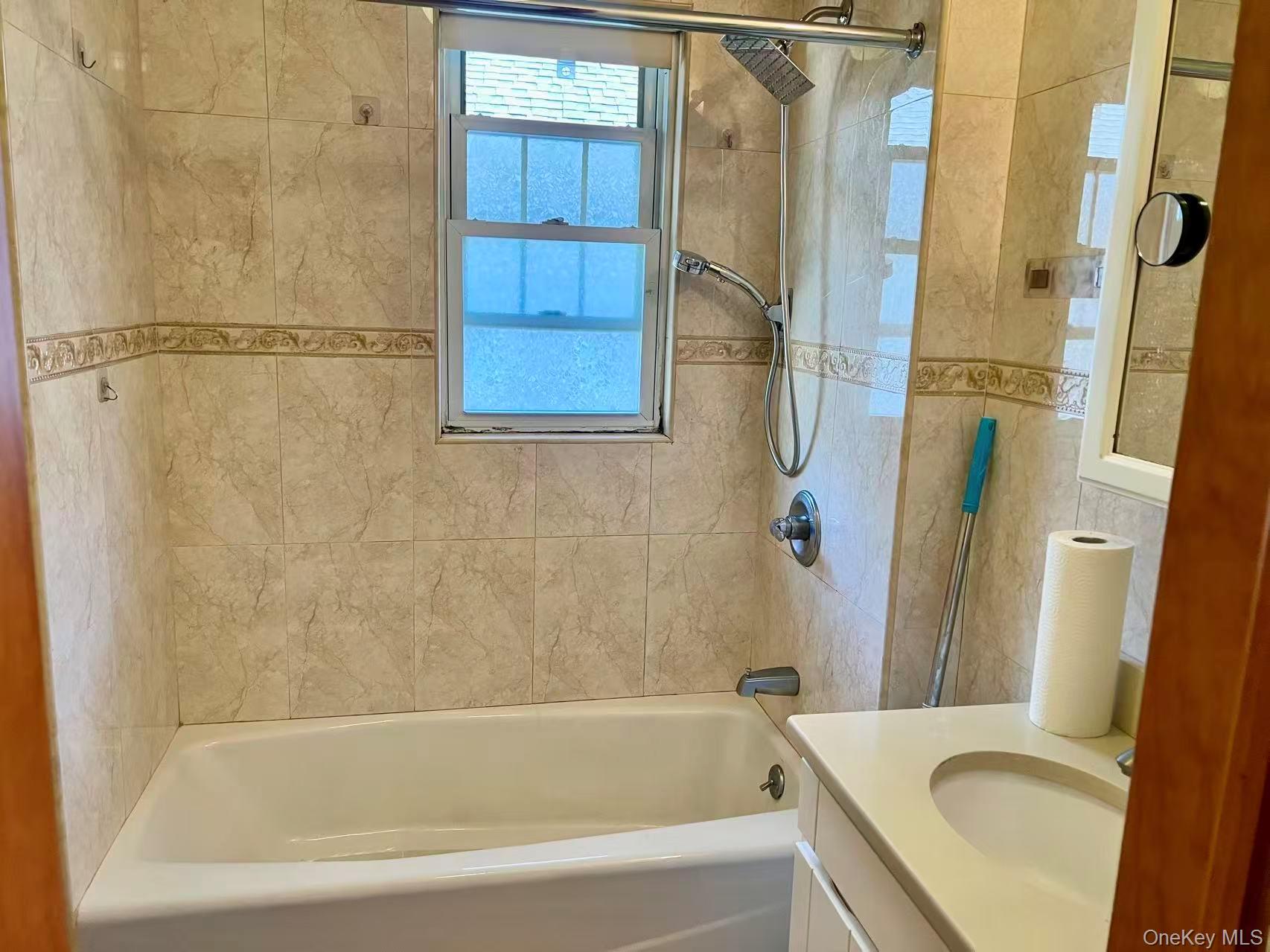 149-15 15th Road Queens, NY 11357 - Photo 14 of 20 a bathroom with a tub a sink and a shower