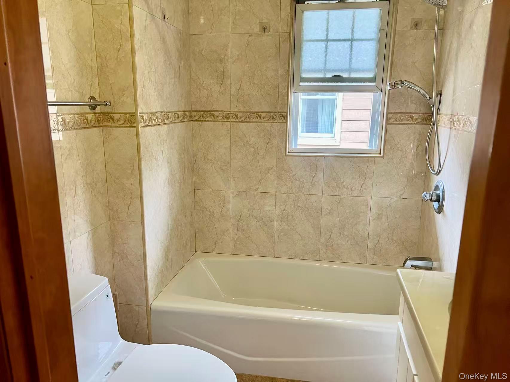 149-15 15th Road Queens, NY 11357 - Photo 15 of 20 a bathroom with a bathtub and a shower