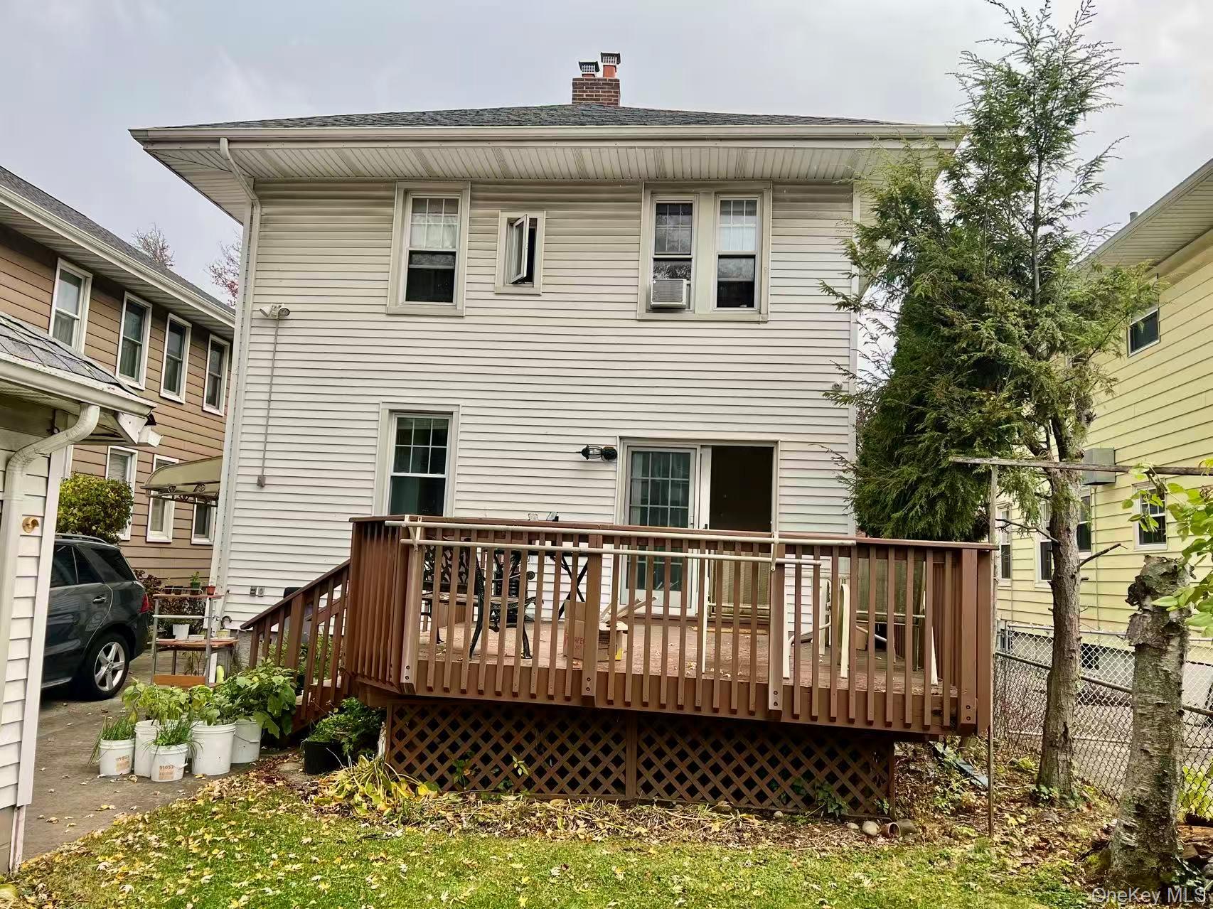 149-15 15th Road Queens, NY 11357 - Photo 16 of 20 a view of a house with a wooden deck