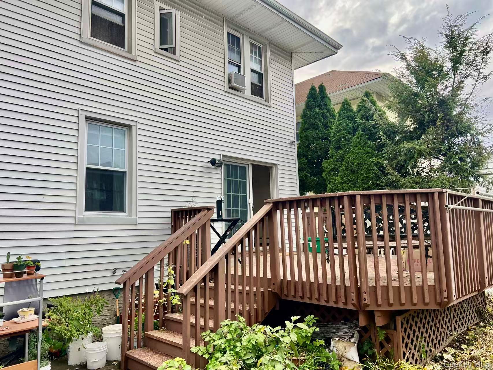 149-15 15th Road Queens, NY 11357 - Photo 17 of 20 a view of a house with wooden deck and furniture