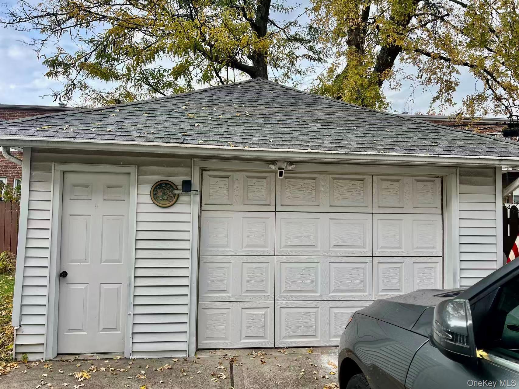149-15 15th Road Queens, NY 11357 - Photo 19 of 20 a view of a house with a door and a tree