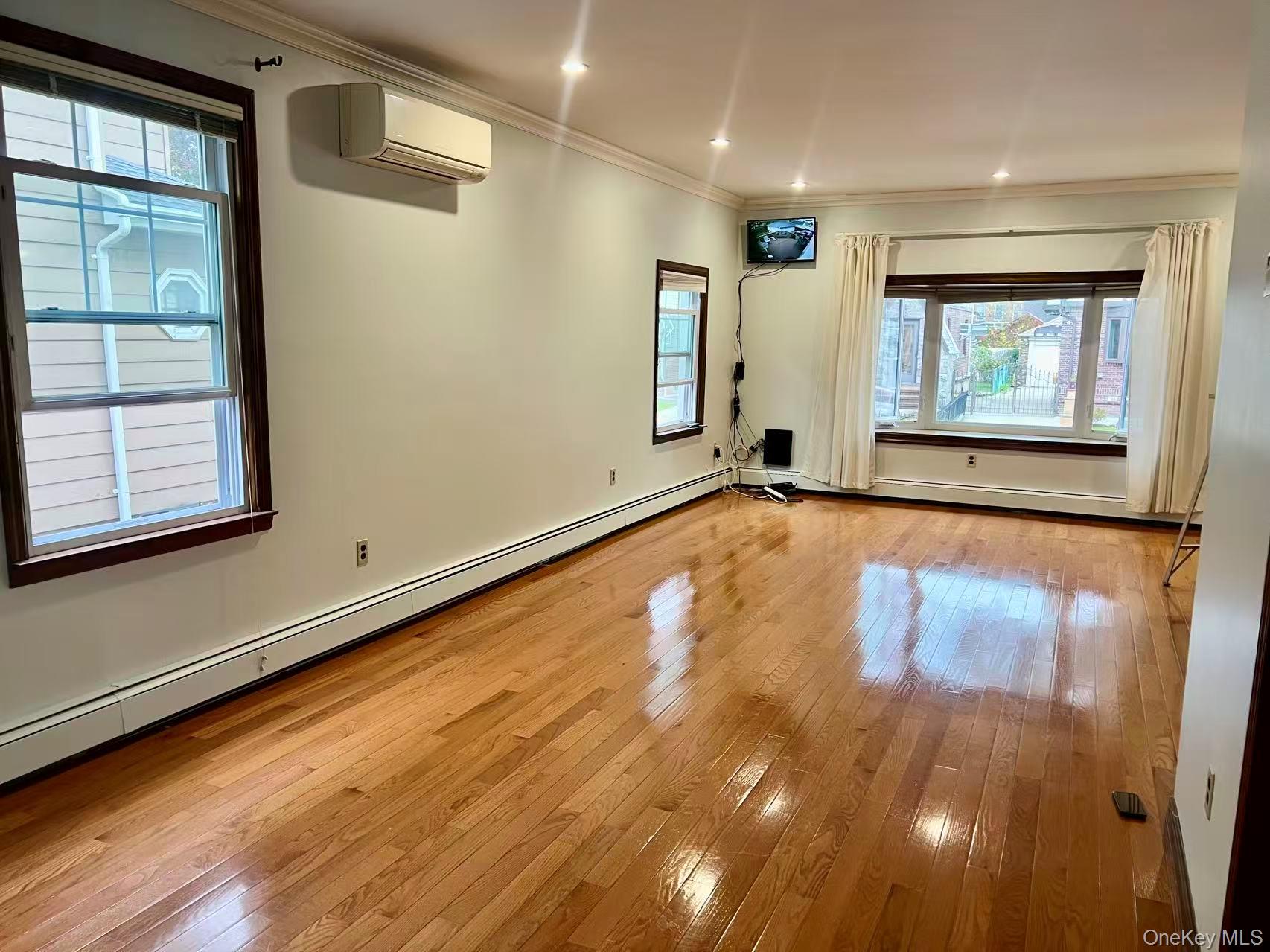 149-15 15th Road Queens, NY 11357 - Photo 2 of 20 a view of room with window and wooden floor