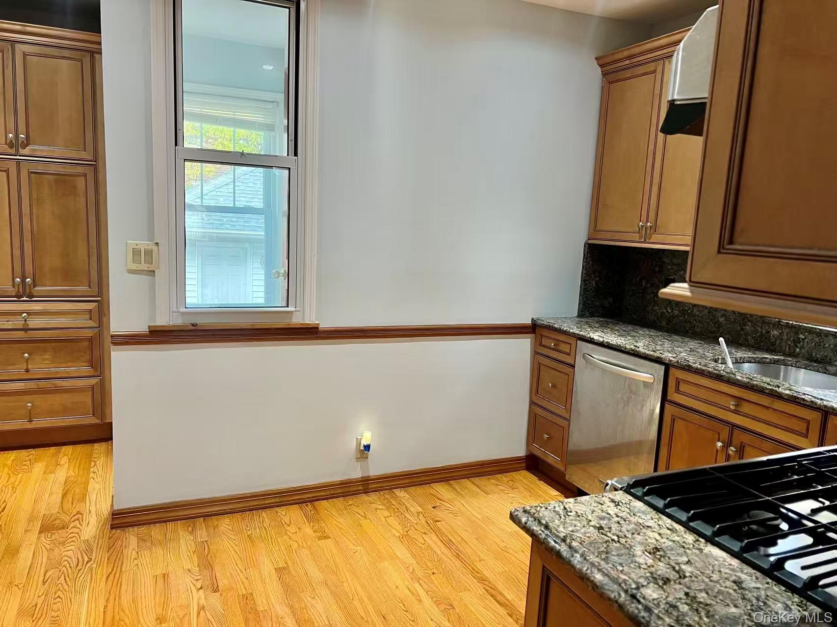 149-15 15th Road Queens, NY 11357 - Photo 5 of 20 a kitchen with a stove and a microwave