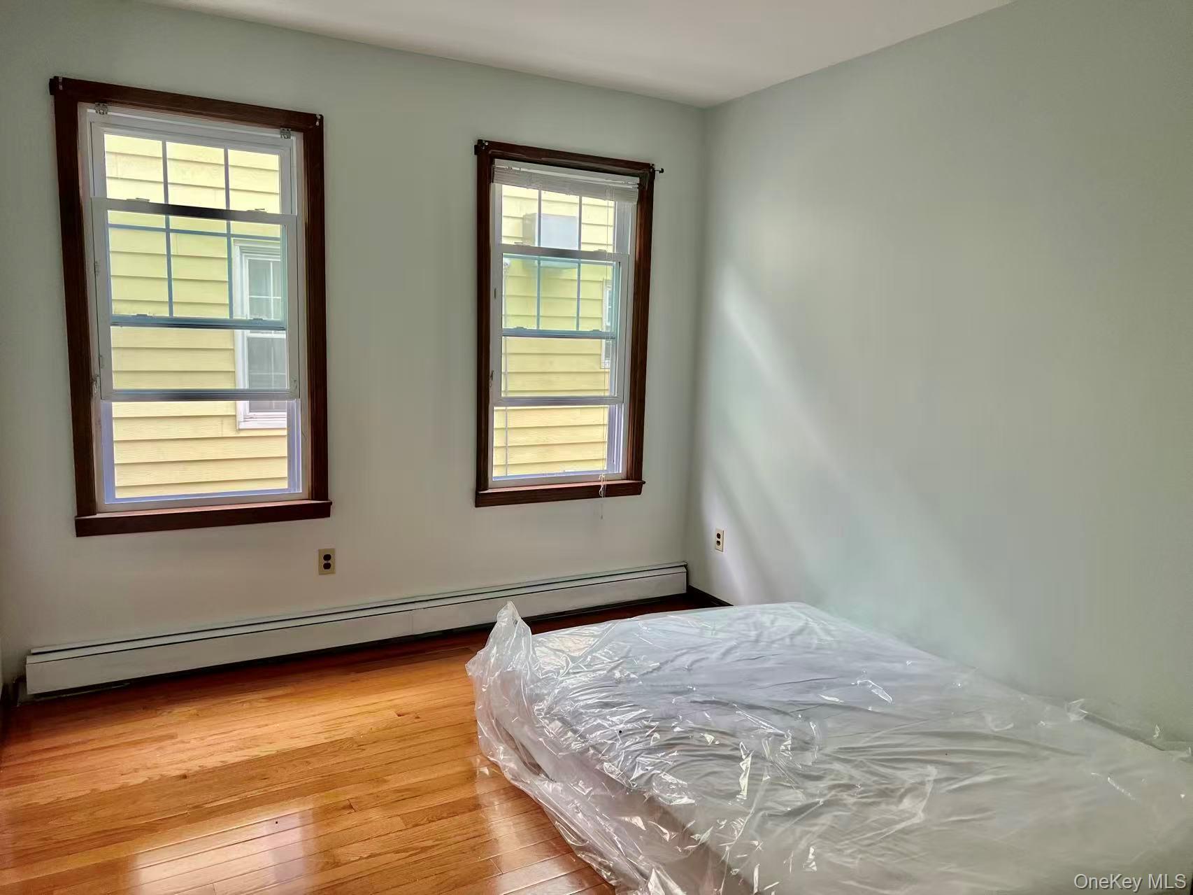 149-15 15th Road Queens, NY 11357 - Photo 6 of 20 a bedroom with a bed and a window