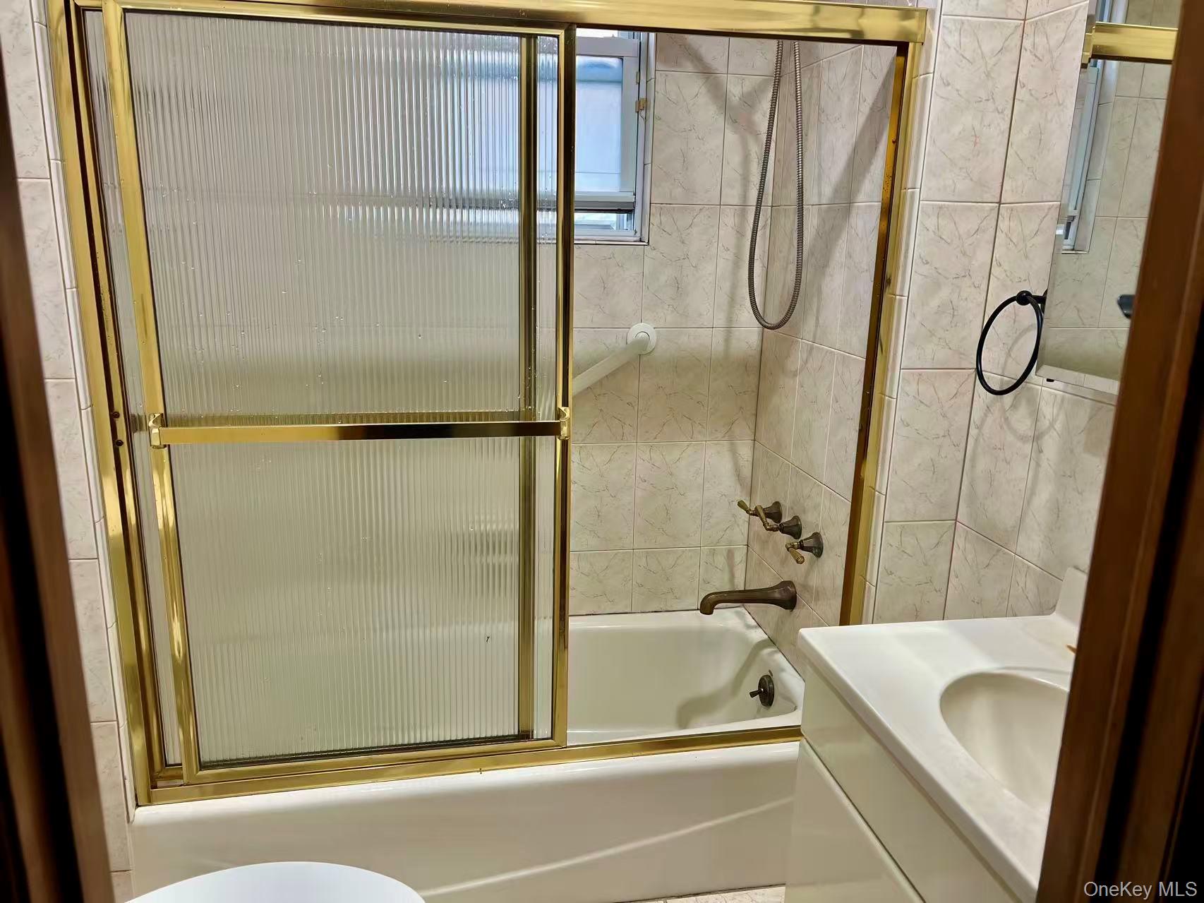 149-15 15th Road Queens, NY 11357 - Photo 7 of 20 a bathroom with a tub and a shower