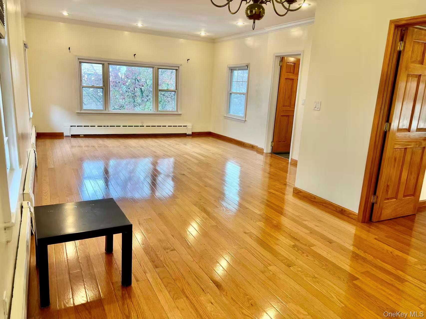 149-15 15th Road Queens, NY 11357 - Photo 9 of 20 a view of a hallway with wooden floor and entryway
