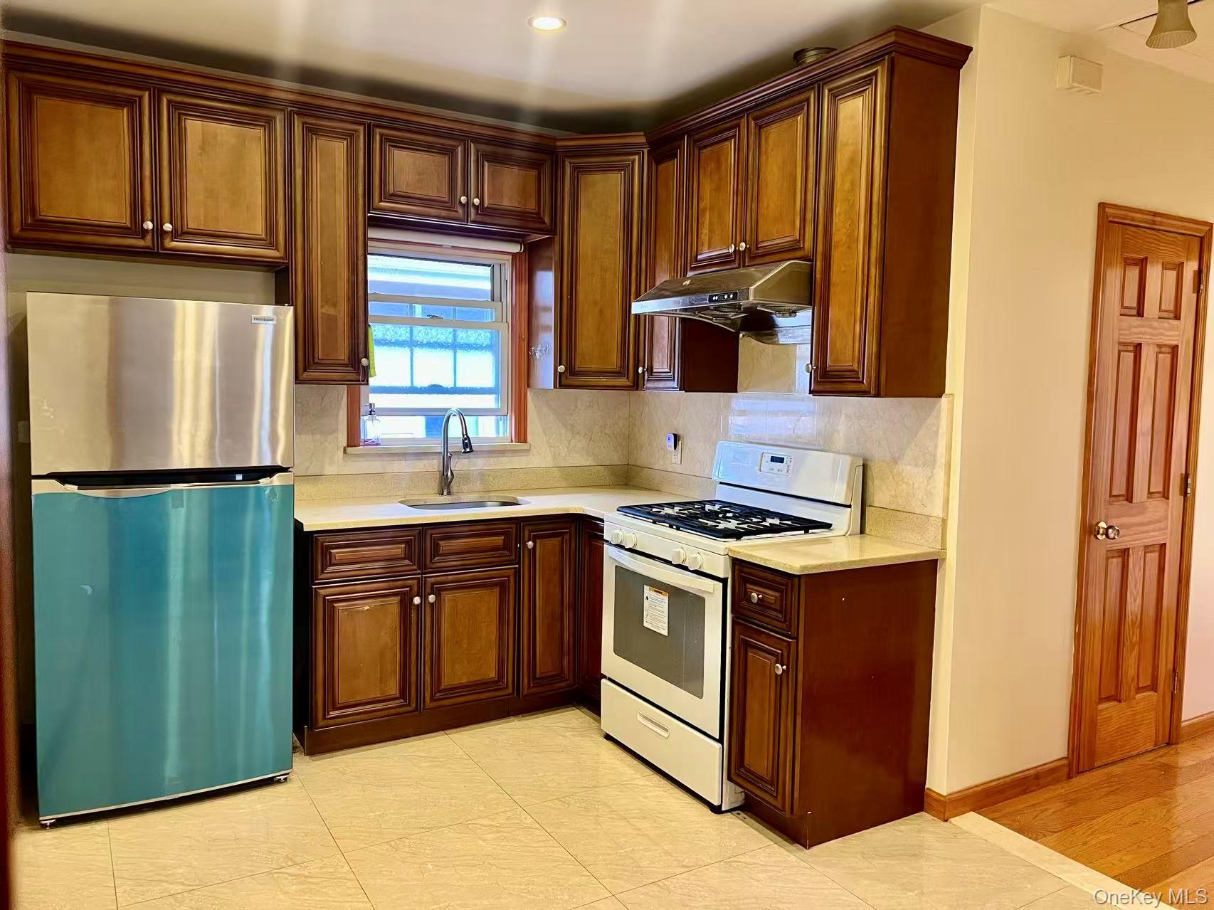 149-15 15th Road Queens, NY 11357 - Photo 10 of 20 a kitchen with stainless steel appliances granite countertop a stove a sink and a refrigerator