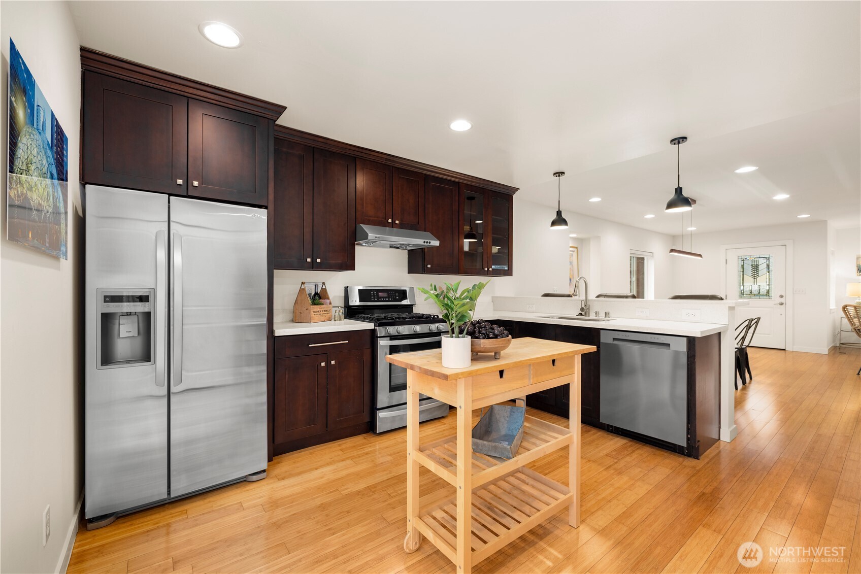 1029 Southwest 124th Street Burien, WA 98146 - Photo 9 of 40 a kitchen with a refrigerator a counter top space and cabinets