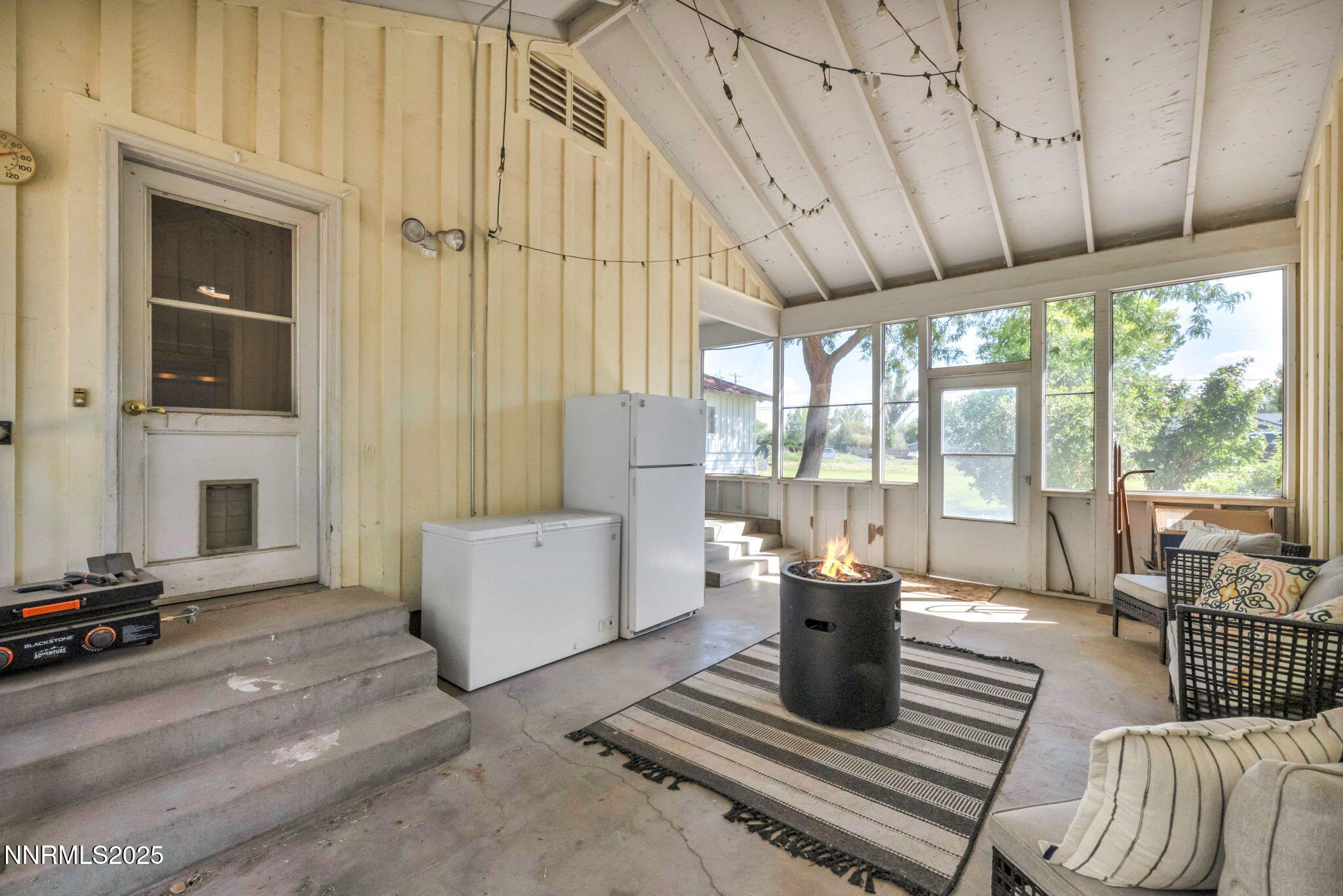 2998 Alcorn Road Fallon, NV 89406 - Photo 19 of 42 a living room with furniture a fireplace and large windows