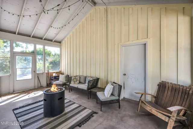 a bedroom with a bed a flat screen tv and a window