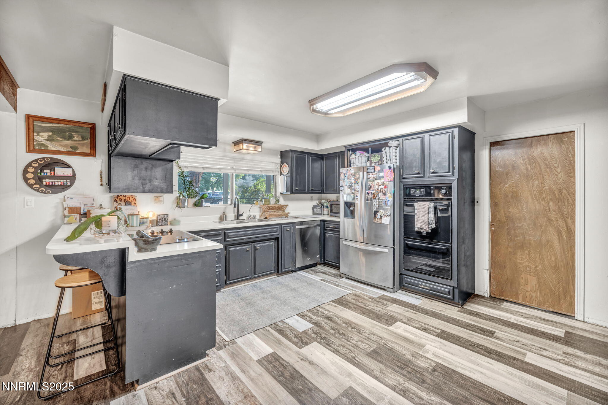 2998 Alcorn Road Fallon, NV 89406 - Photo 10 of 42 a kitchen with stainless steel appliances kitchen island granite countertop a refrigerator and a stove top oven
