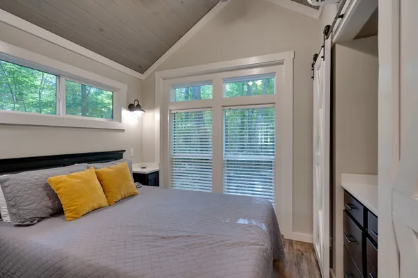 a bedroom with a bed and a large window