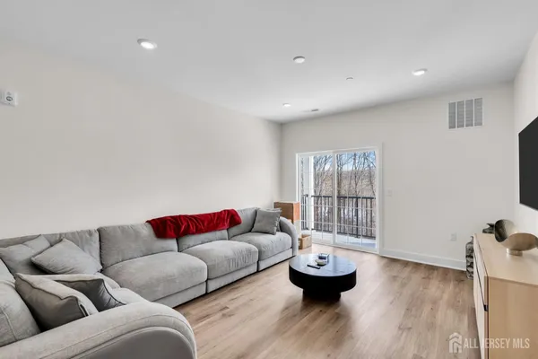 a living room with furniture and wooden floor