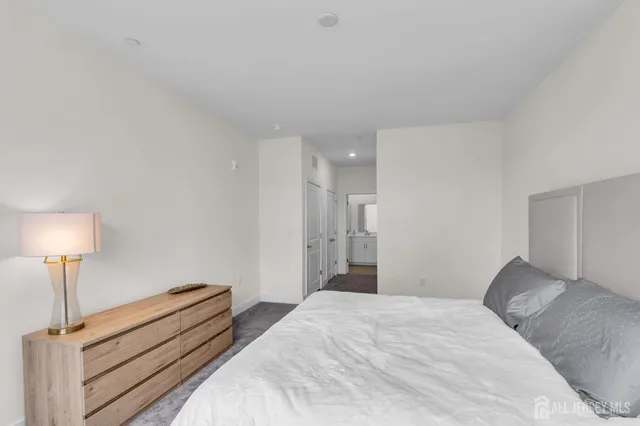 a bedroom with a bed and a lamp