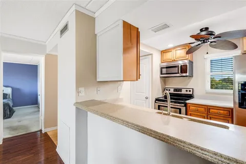 a kitchen with stainless steel appliances granite countertop a sink and a stove top oven