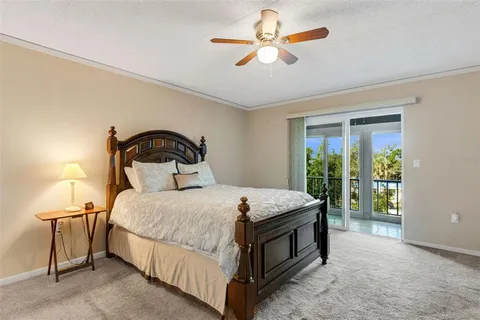 a bedroom with a bed a chandelier and a table