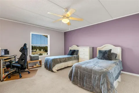 a bedroom with two beds and a chandelier
