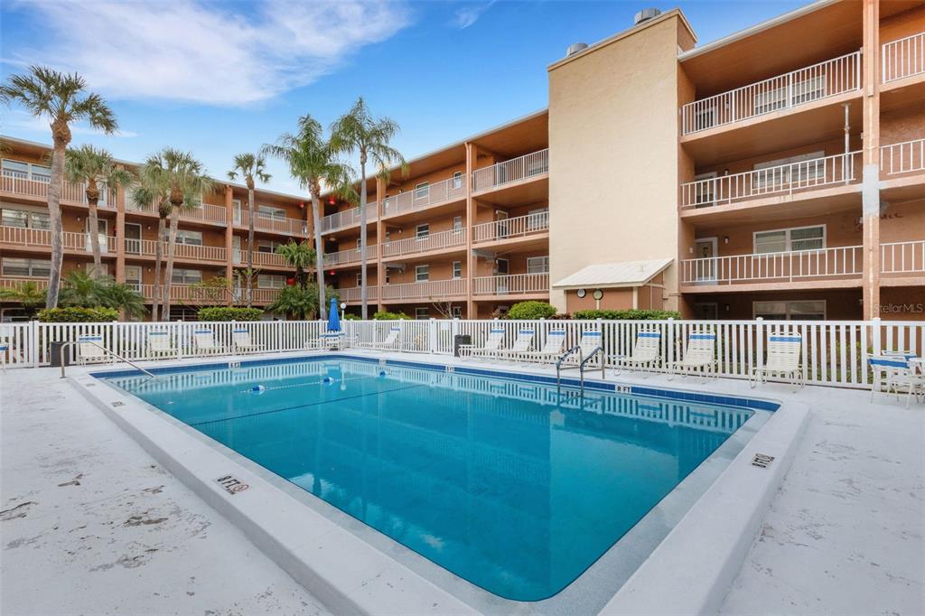 12760 Indian Rocks Road, Unit 119 Largo, FL 33774 - Photo 20 of 24 a swimming pool view with a outdoor seating