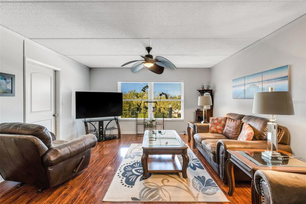 12760 Indian Rocks Road, Unit 119 Largo, FL 33774 - Photo 4 of 24 a living room with furniture and a flat screen tv