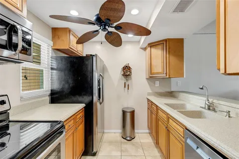 a kitchen with a sink a stove and a refrigerator