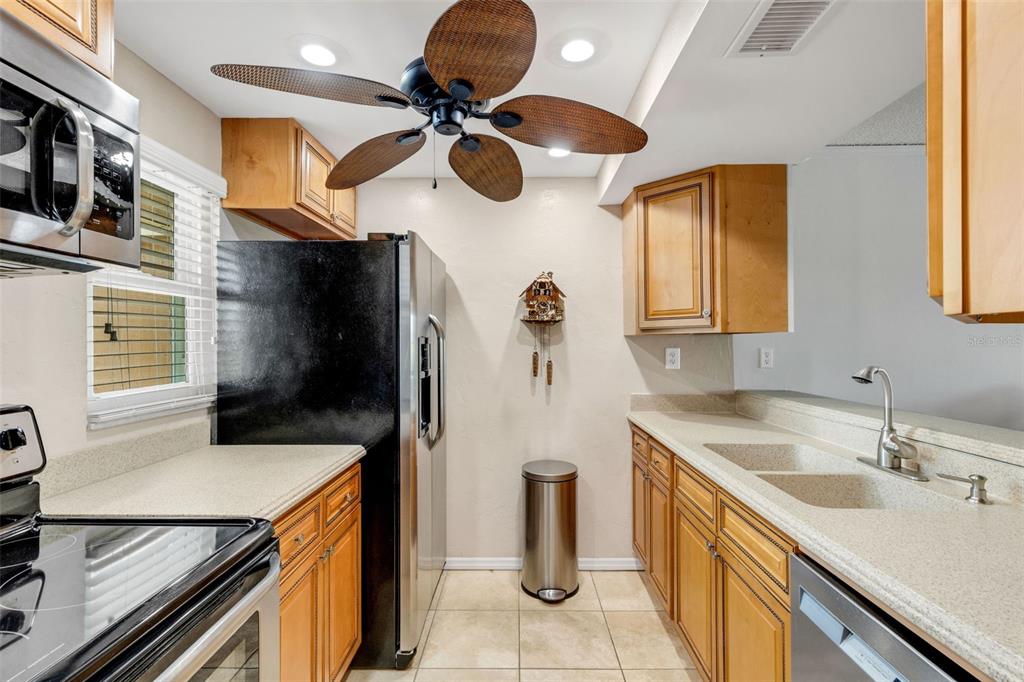 12760 Indian Rocks Road, Unit 119 Largo, FL 33774 - Photo 9 of 24 a kitchen with a sink a stove and a refrigerator