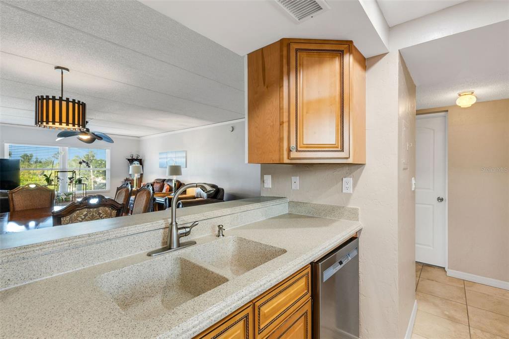 12760 Indian Rocks Road, Unit 119 Largo, FL 33774 - Photo 10 of 24 a kitchen with a sink a counter top space and cabinets