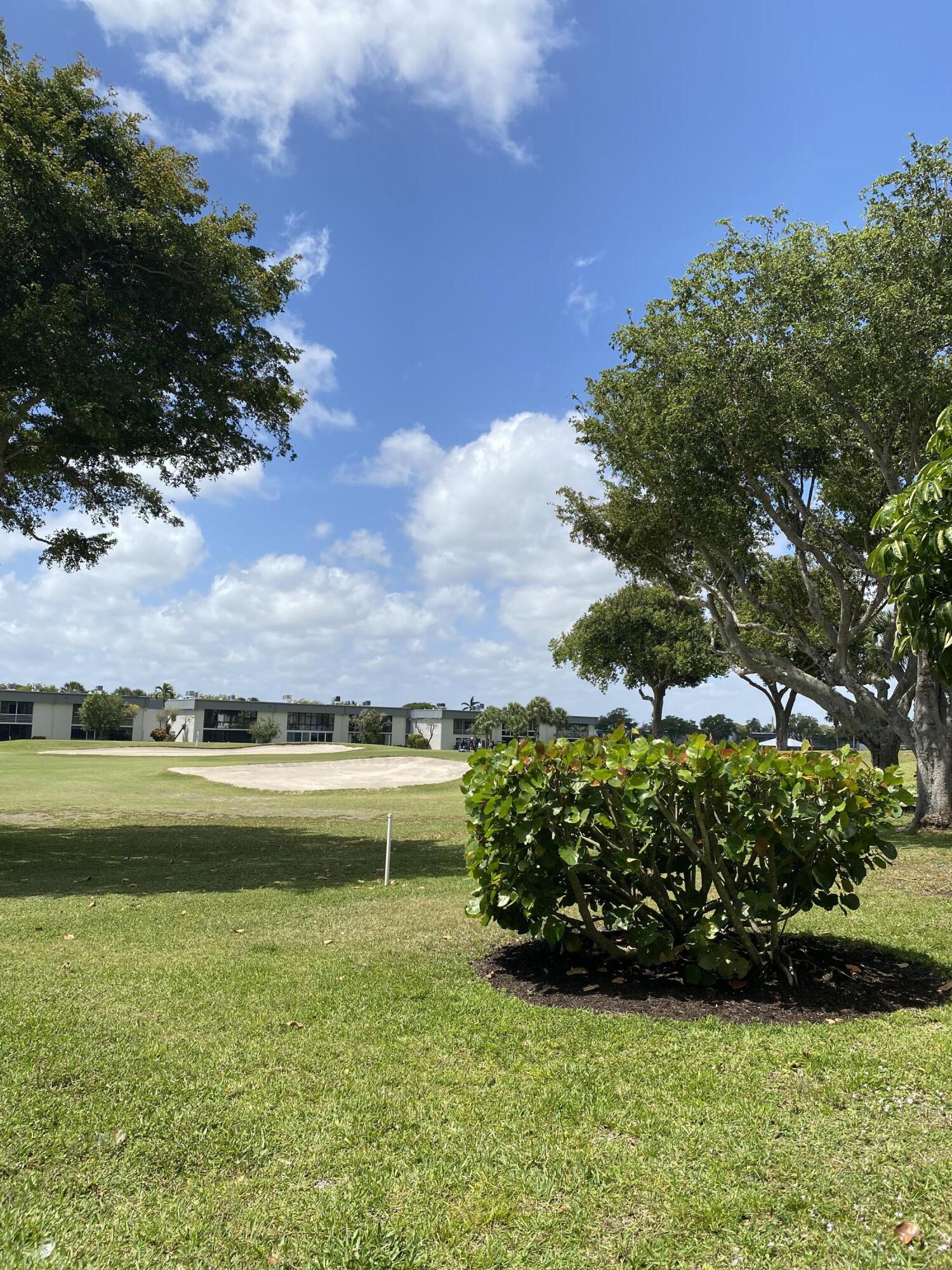 148 Normandy Lane Delray Beach, FL 33484 - Photo 21 of 29 a front view of a house with a garden