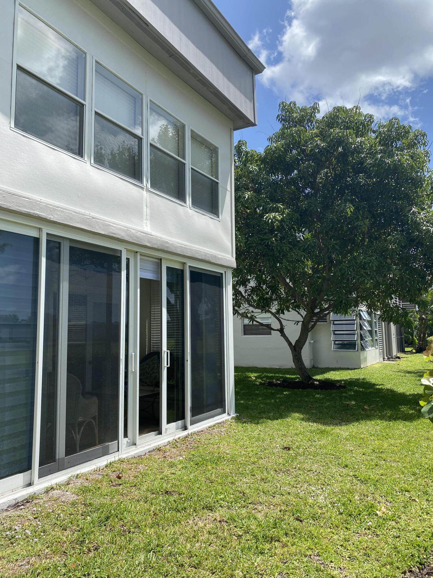 148 Normandy Lane Delray Beach, FL 33484 - Photo 23 of 29 a view of a house with a yard and large tree