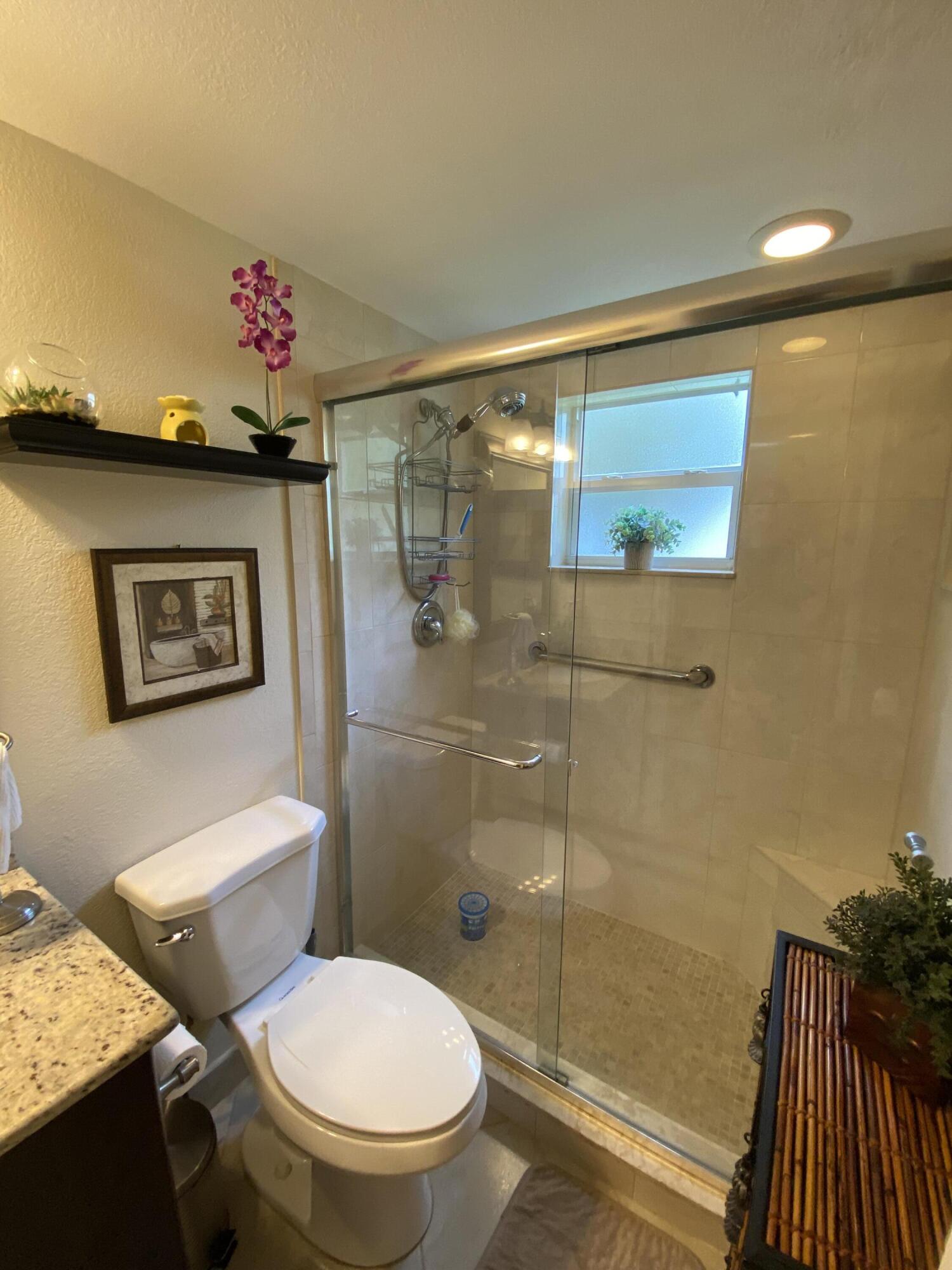 148 Normandy Lane Delray Beach, FL 33484 - Photo 29 of 29 a bathroom with a toilet a sink and shower