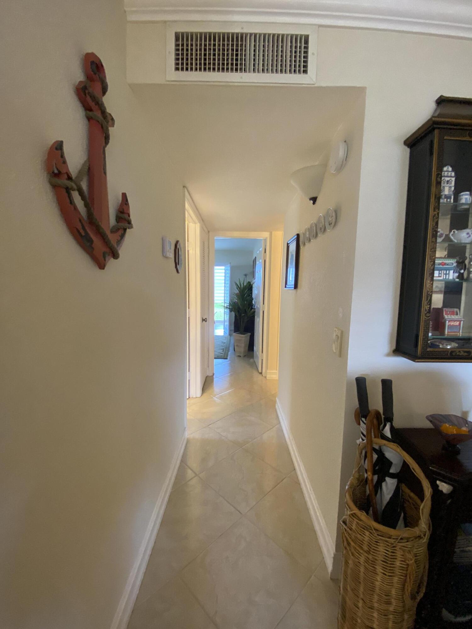 148 Normandy Lane Delray Beach, FL 33484 - Photo 8 of 29 a view of a hallway with a window