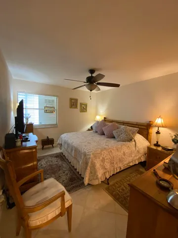 a bedroom with bed and window