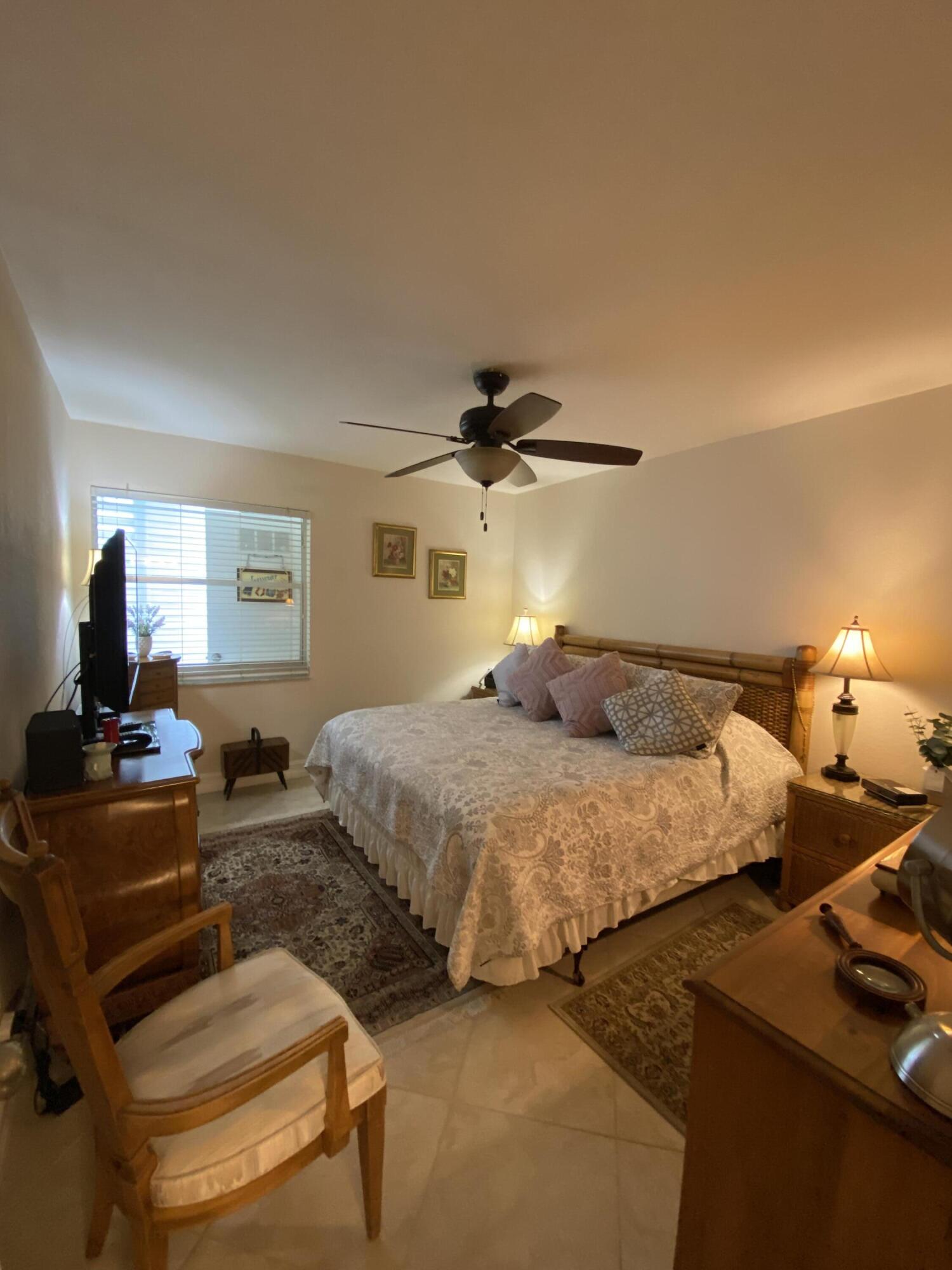 148 Normandy Lane Delray Beach, FL 33484 - Photo 9 of 29 a bedroom with bed and window