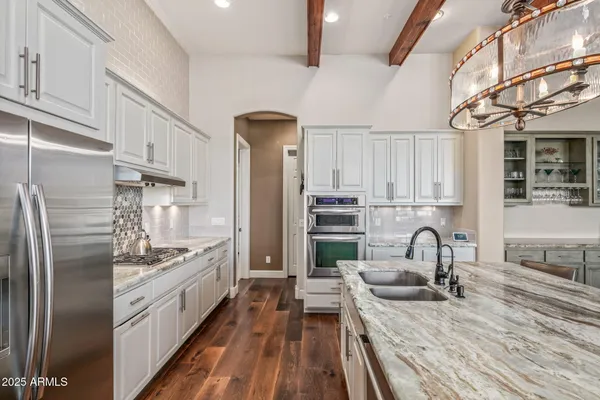 a kitchen with refrigerator and cabinets