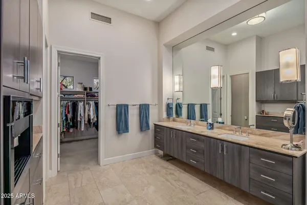 a bathroom with a double vanity sink and a mirror