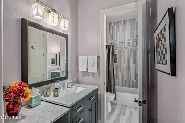 a bathroom with a sink vanity and a mirror