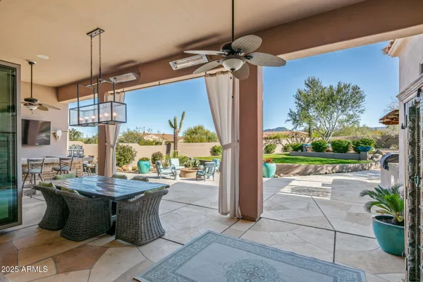 a view of a patio with a dining table and chairs