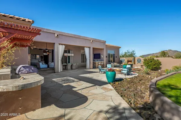 a view of living room with patio furniture and fire pit