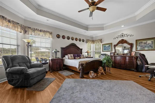 a living room with furniture a flat screen tv and a dresser