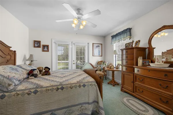 a view of a hallway and a livingroom with furniture