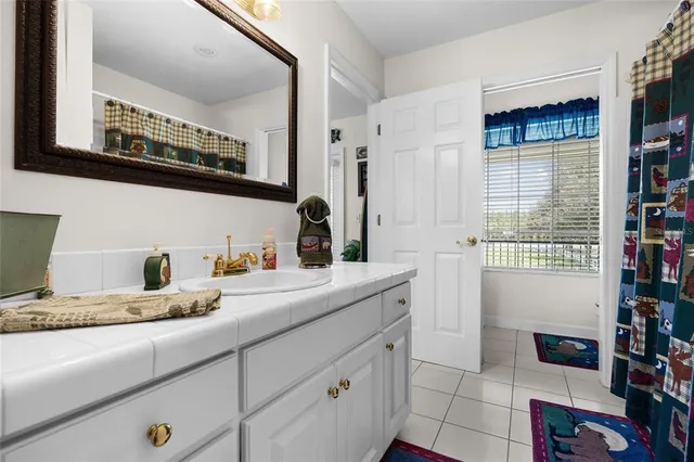 a living room with furniture and floor to ceiling windows