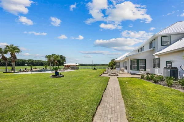 a view of a kitchen with stainless steel appliances granite countertop a stove and a sink