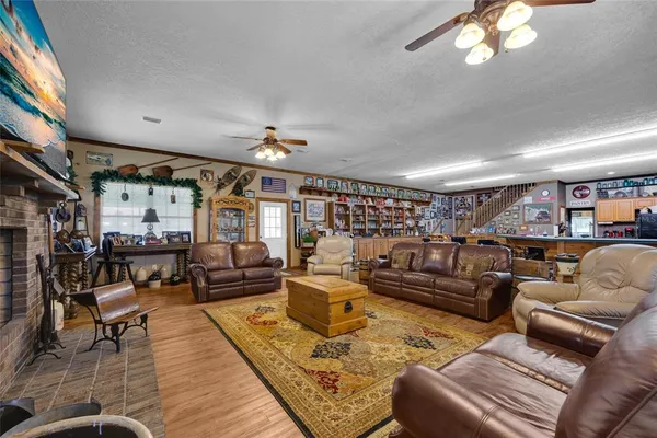 a view of a house with a garden and sitting area