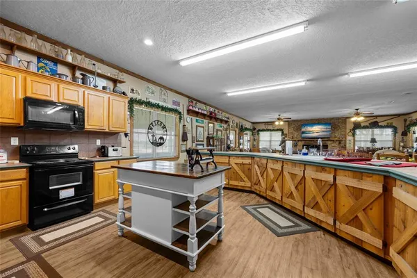 a view of a house with a big yard and potted plants