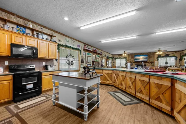 a view of a house with a big yard and potted plants