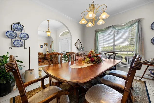 a view of a dining room with furniture and chandelier