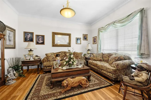 a white kitchen with granite countertop a sink window and white appliances