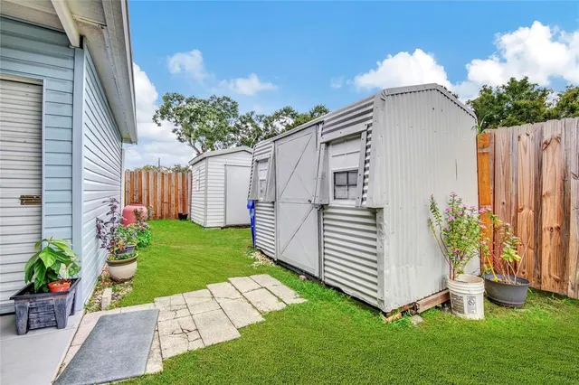 a view of a house with a yard and a garden