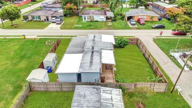 an aerial view of multiple houses with yard