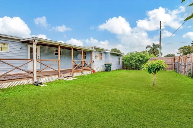 a view of a house with backyard and a patio