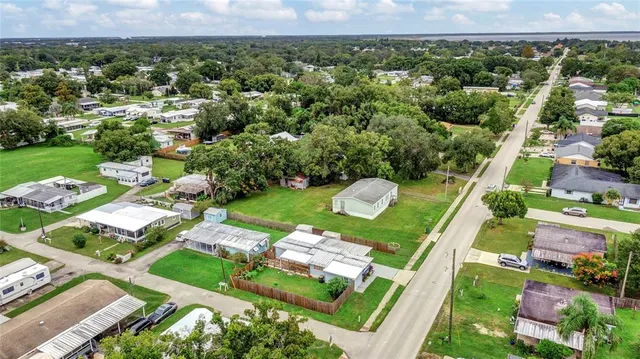 an aerial view of a residential houses with outdoor space and street view